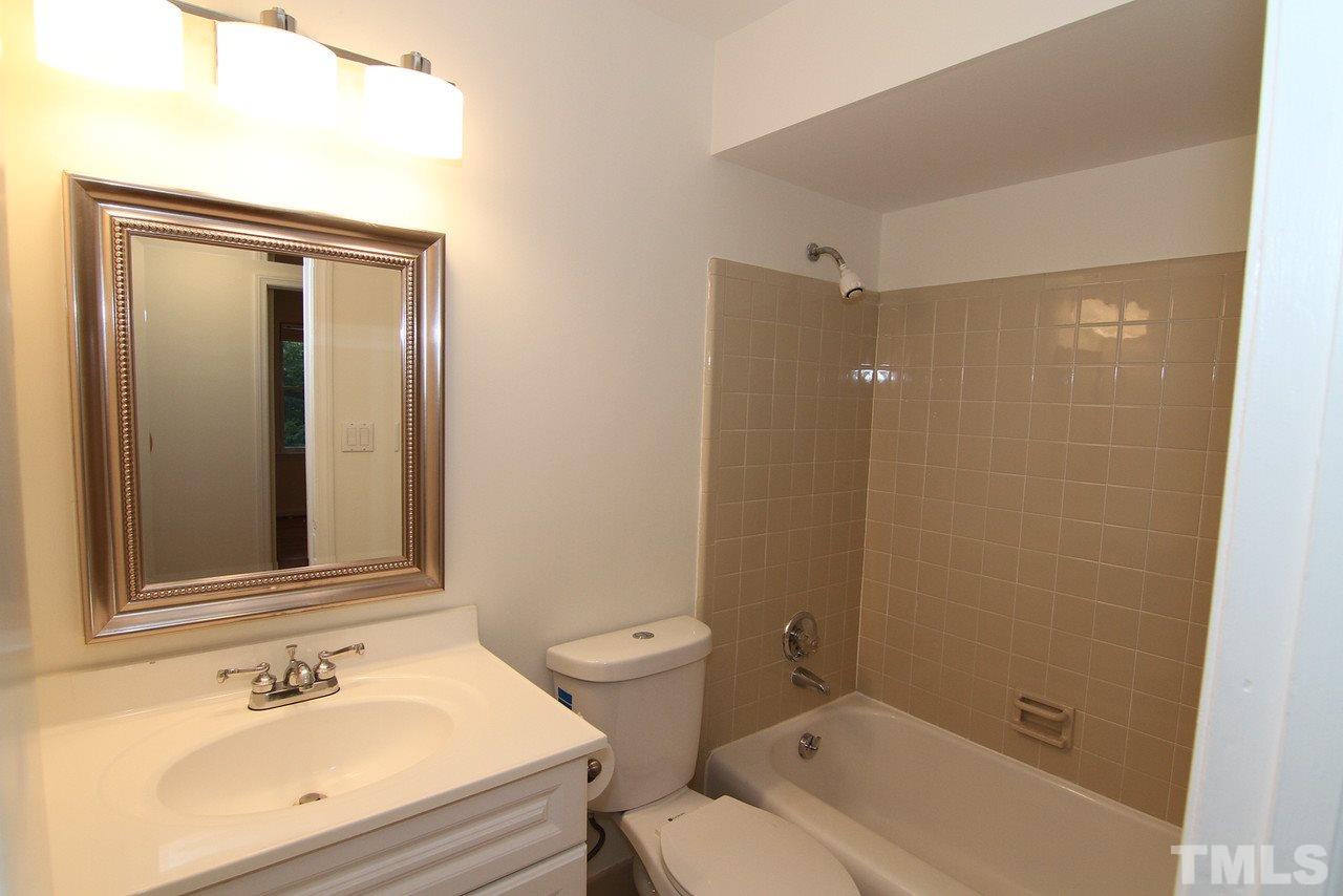 4208 Rowan Street Raleigh, NC 27609 - Photo 10 of 14 a bathroom with a sink toilet and shower