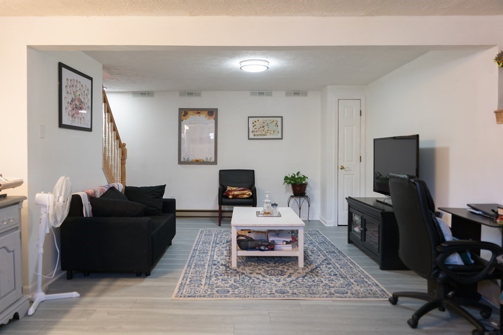 75 Fairview Park Road Sturbridge, MA 01566 - Photo 11 of 13 a living room with furniture and a flat screen tv
