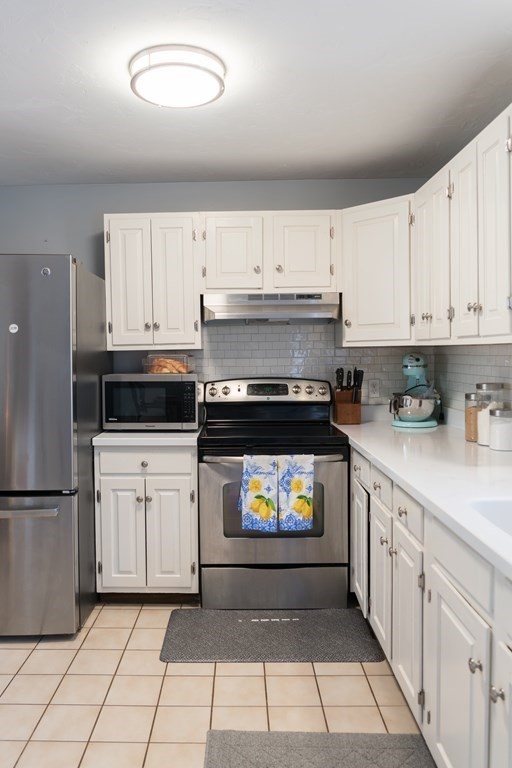 75 Fairview Park Road Sturbridge, MA 01566 - Photo 6 of 13 a kitchen with stainless steel appliances kitchen island granite countertop a stove a sink and a white cabinets