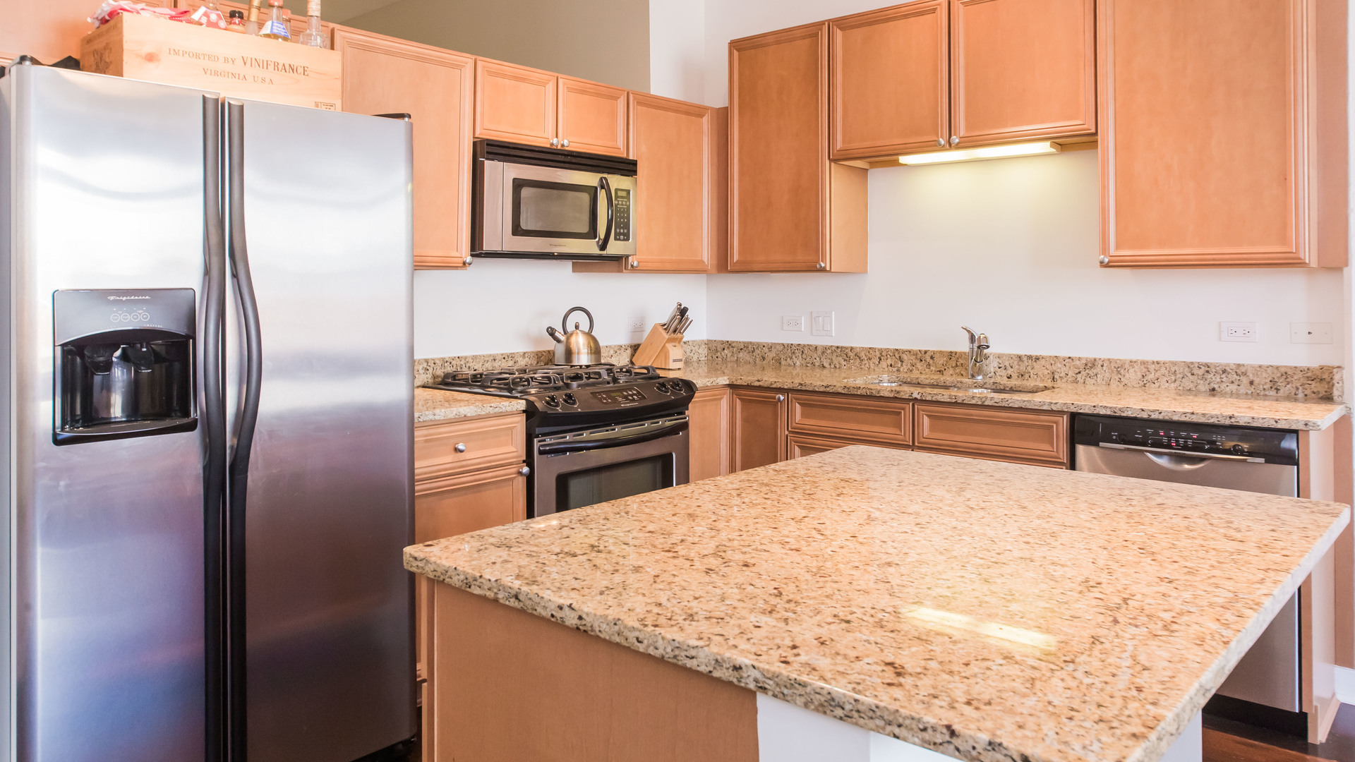 901 West Madison Street, Unit 609 Chicago, IL 60607 - Photo 12 of 22 a kitchen with stainless steel appliances granite countertop a sink stove and refrigerator