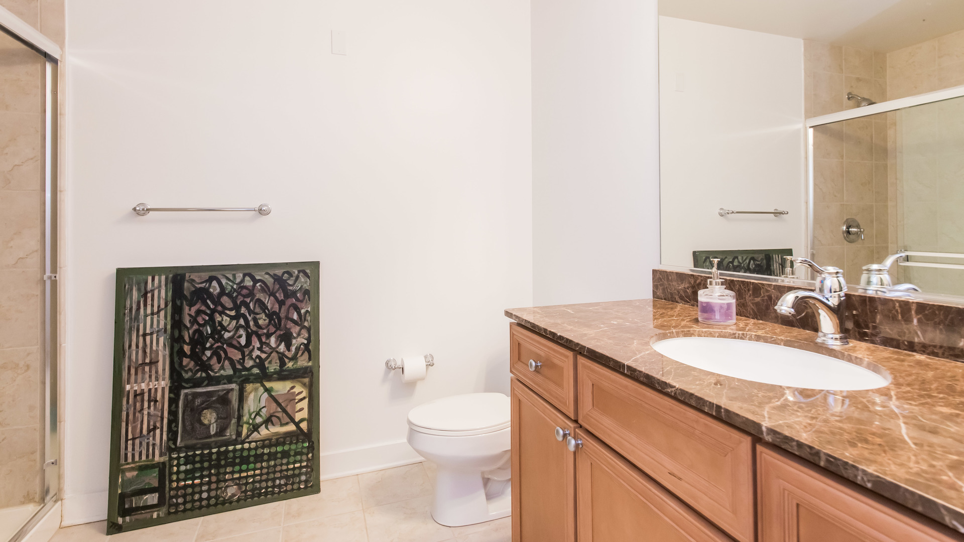 901 West Madison Street, Unit 609 Chicago, IL 60607 - Photo 20 of 22 a bathroom with a granite countertop toilet a sink and a mirror