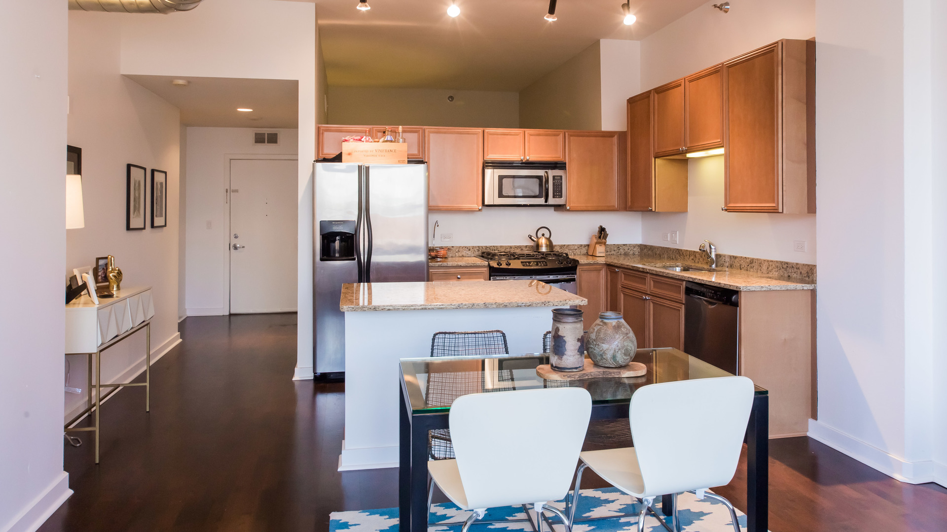 901 West Madison Street, Unit 609 Chicago, IL 60607 - Photo 4 of 22 a view of a dining room with furniture and wooden floor