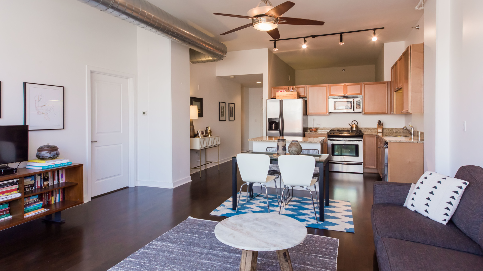 901 West Madison Street, Unit 609 Chicago, IL 60607 - Photo 6 of 22 a living room with furniture and a wooden floor