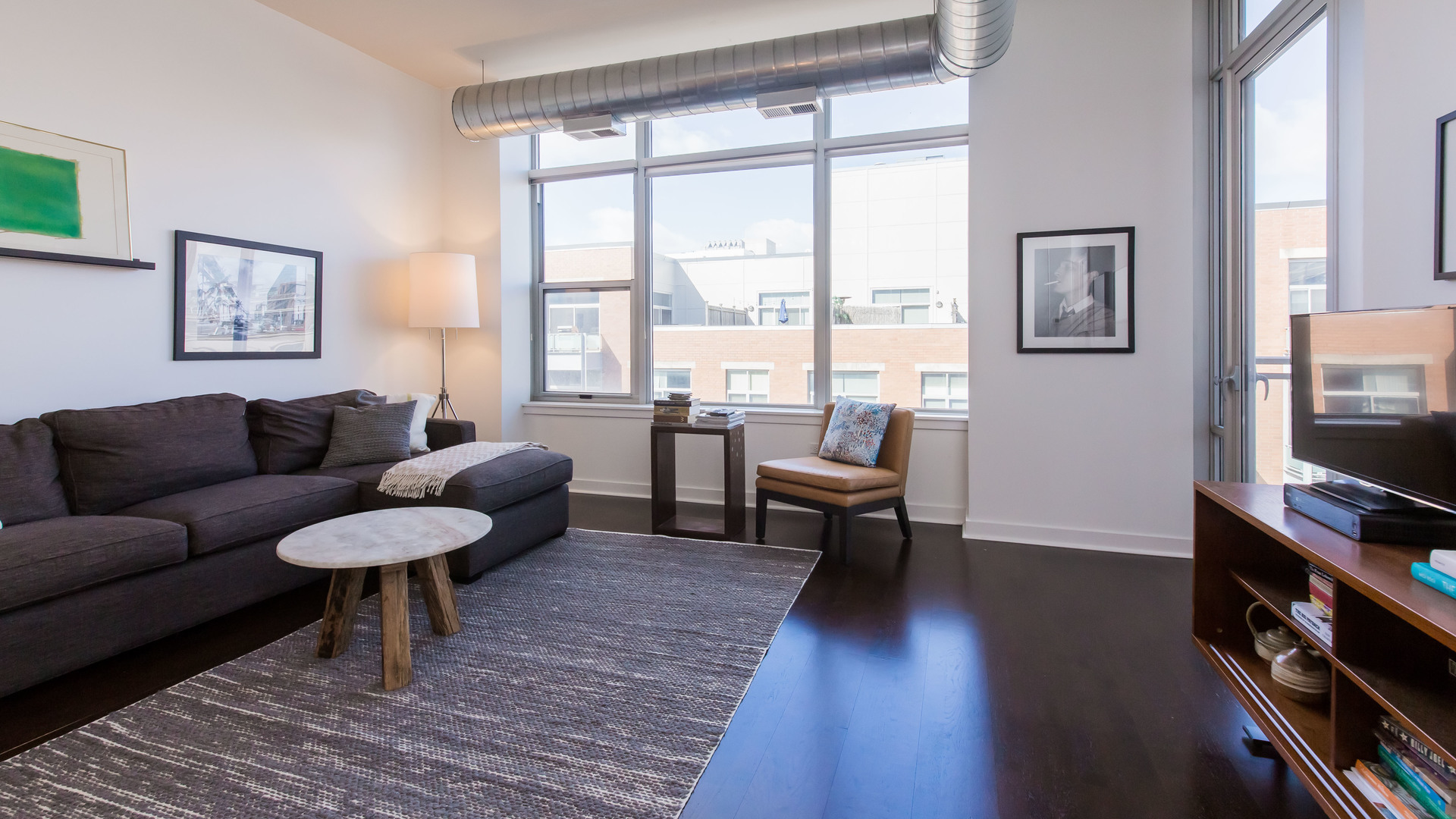 901 West Madison Street, Unit 609 Chicago, IL 60607 - Photo 7 of 22 a living room with furniture and a flat screen tv