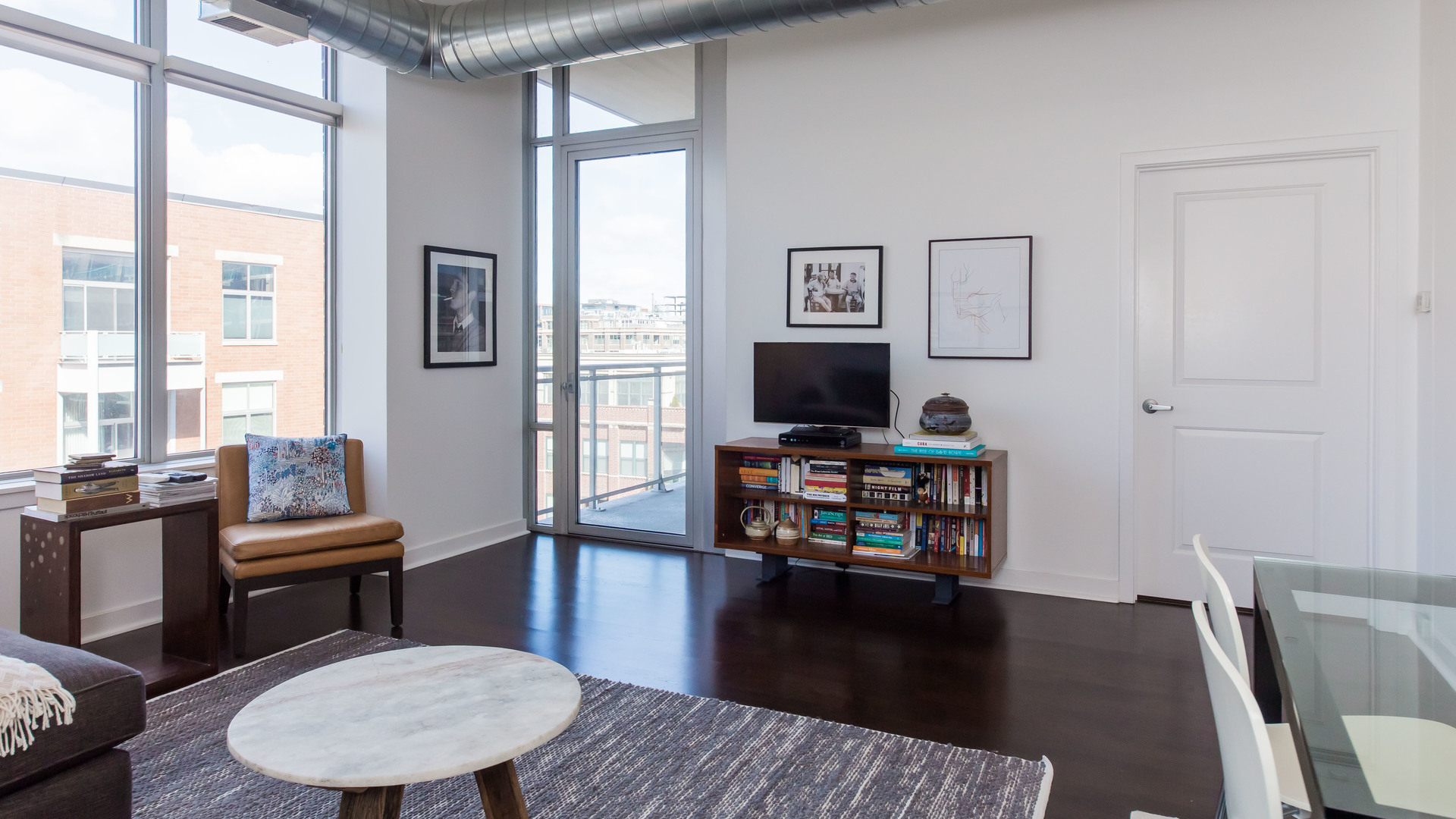 901 West Madison Street, Unit 609 Chicago, IL 60607 - Photo 8 of 22 a living room with furniture a flat screen tv and a window