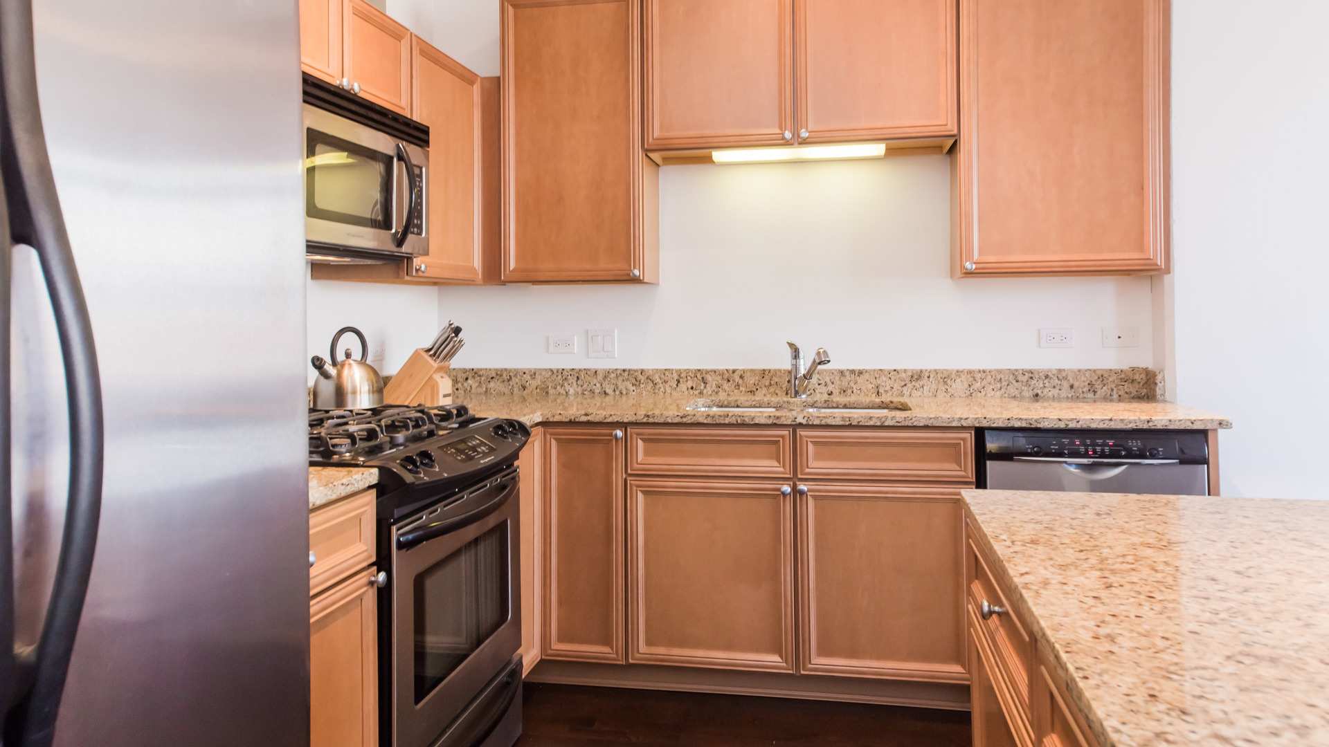 901 West Madison Street, Unit 609 Chicago, IL 60607 - Photo 10 of 22 a kitchen with stainless steel appliances granite countertop a refrigerator stove and sink