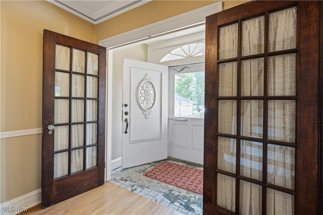 24510 Lake Road Bay Village, OH 44140 - Photo 6 of 45 Foyer entrance featuring light wood-style flooring and crown molding