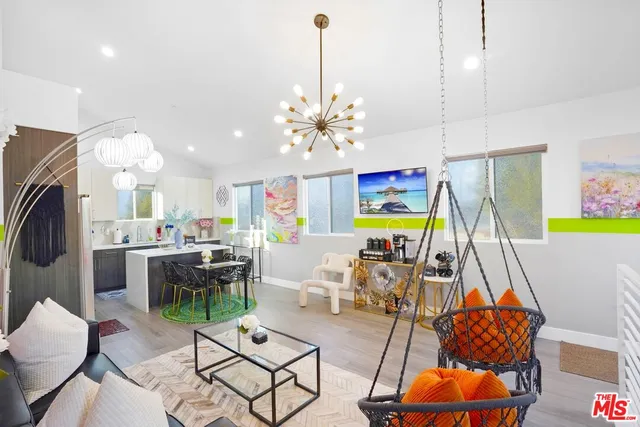 a living room with furniture a fireplace and a chandelier
