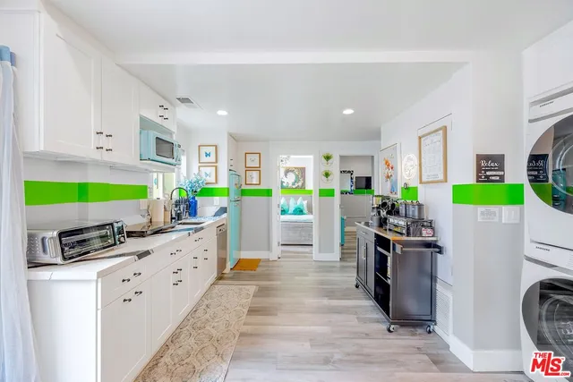 a kitchen with stainless steel appliances kitchen island wooden cabinets refrigerator and stove