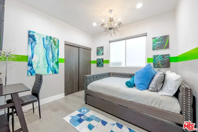 a bed room with a bed window and a chair