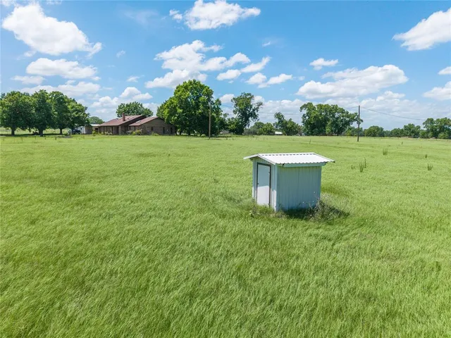 a view of a house with a yard and sitting area