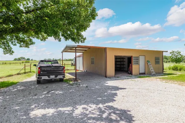 a view of a house with a yard and garage