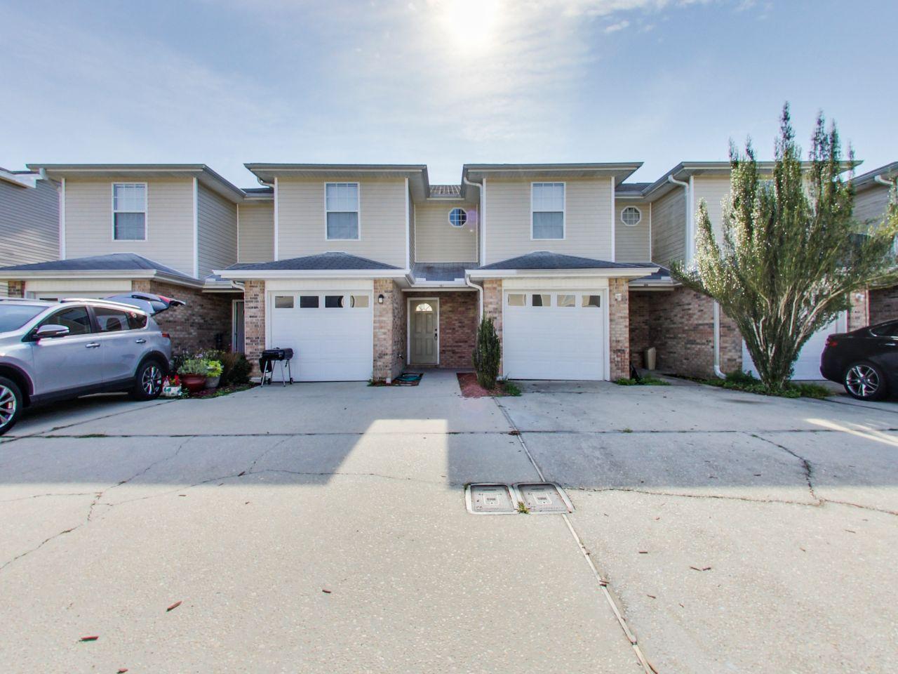 487 Keystone Road, Unit 487 Mary Esther, FL 32569 - Photo 1 of 28 a front view of a house with a garden