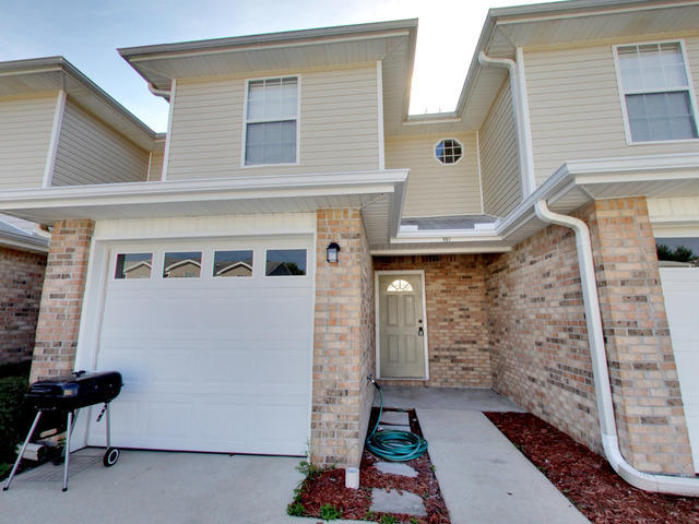 487 Keystone Road, Unit 487 Mary Esther, FL 32569 - Photo 2 of 28 a front view of a house with chairs