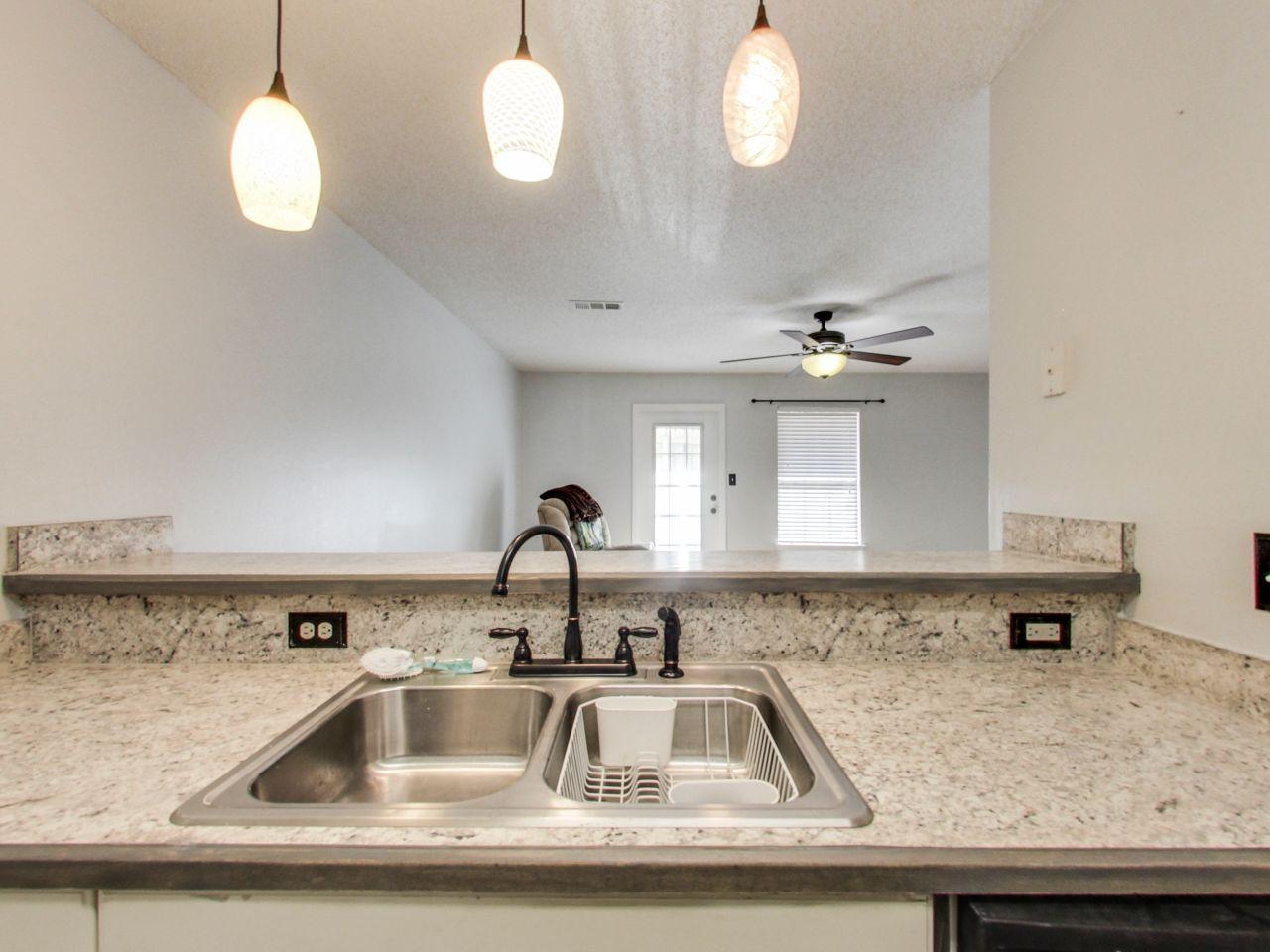 487 Keystone Road, Unit 487 Mary Esther, FL 32569 - Photo 12 of 28 a kitchen with a sink a counter space and cabinets