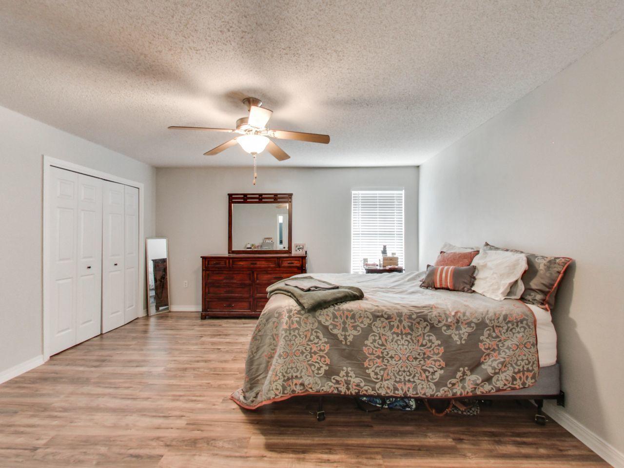 487 Keystone Road, Unit 487 Mary Esther, FL 32569 - Photo 16 of 28 a bedroom with a bed and a chandelier