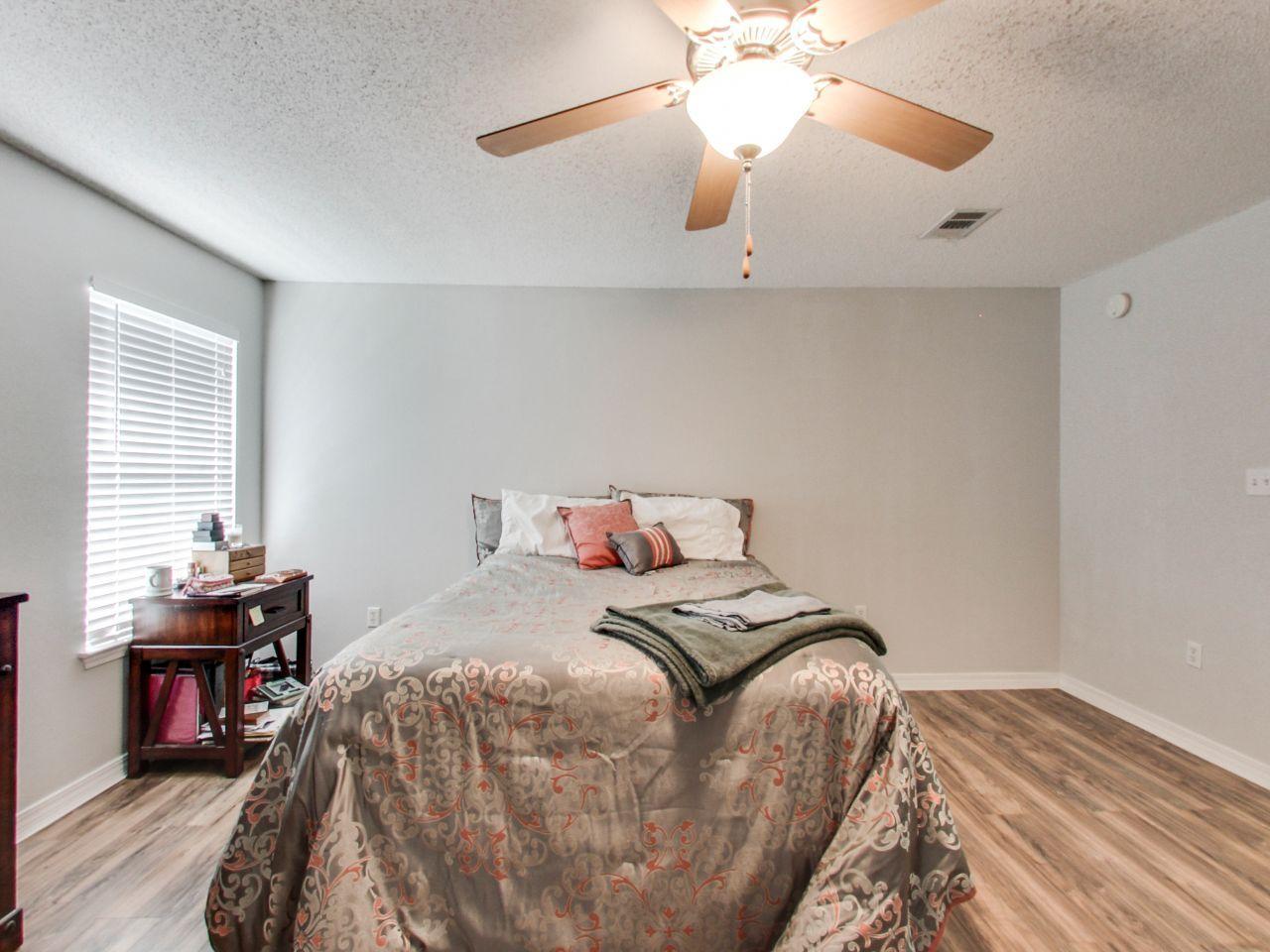 487 Keystone Road, Unit 487 Mary Esther, FL 32569 - Photo 17 of 28 a bedroom with a bed and a chandelier