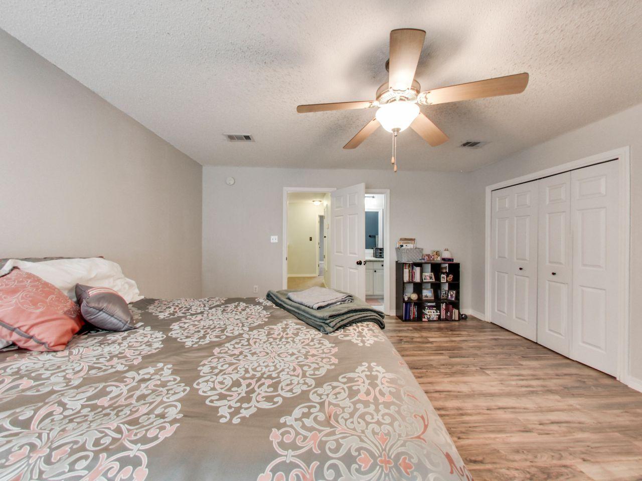487 Keystone Road, Unit 487 Mary Esther, FL 32569 - Photo 18 of 28 a bedroom with a bed and ceiling fan