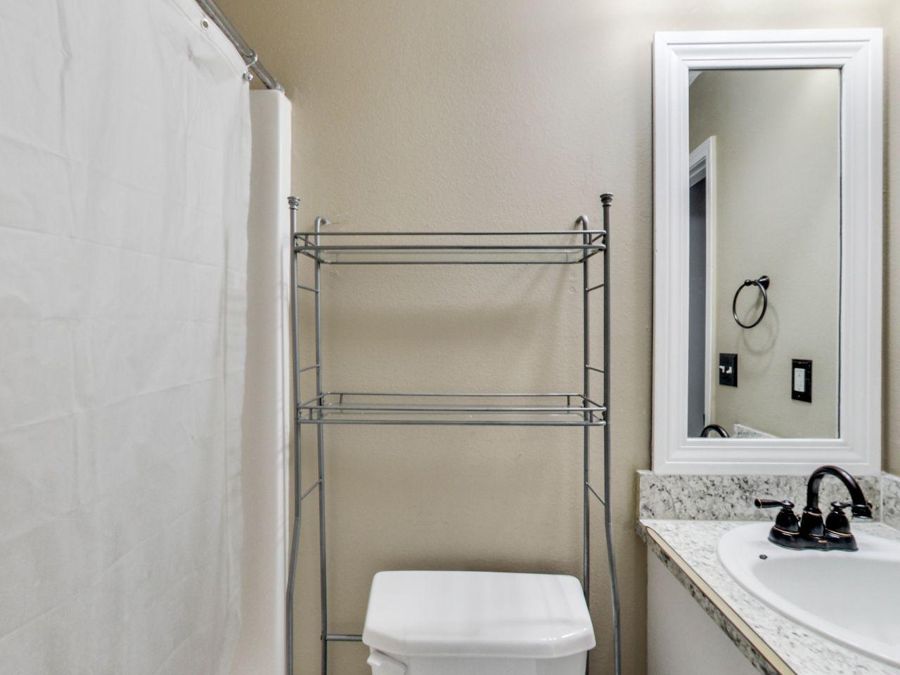 487 Keystone Road, Unit 487 Mary Esther, FL 32569 - Photo 23 of 28 a bathroom with a toilet a sink and a mirror