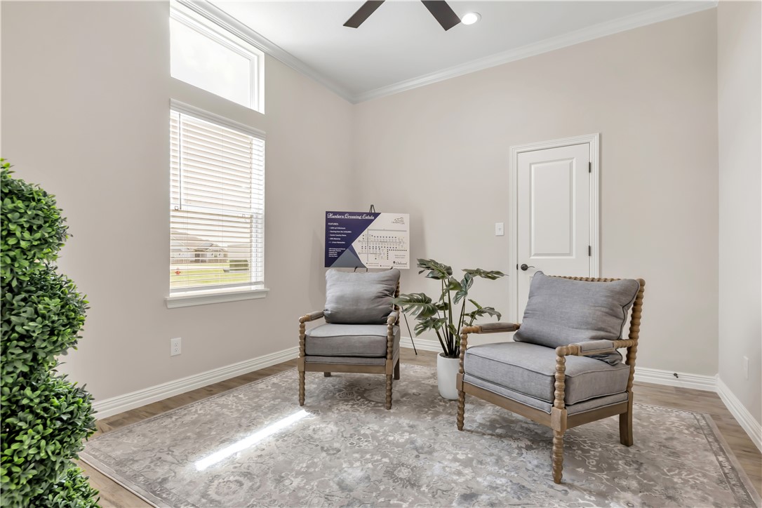 3310 Hunters Crossing Bryan, TX 77808 - Photo 18 of 34 Living area featuring ornamental molding, light wood-style flooring, and a ceiling fan