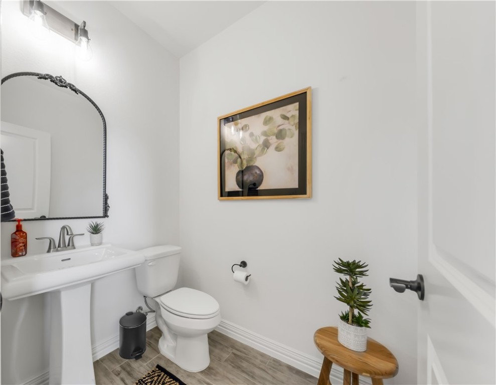 3310 Hunters Crossing Bryan, TX 77808 - Photo 19 of 34 Half bathroom featuring wood tiled floors and baseboards