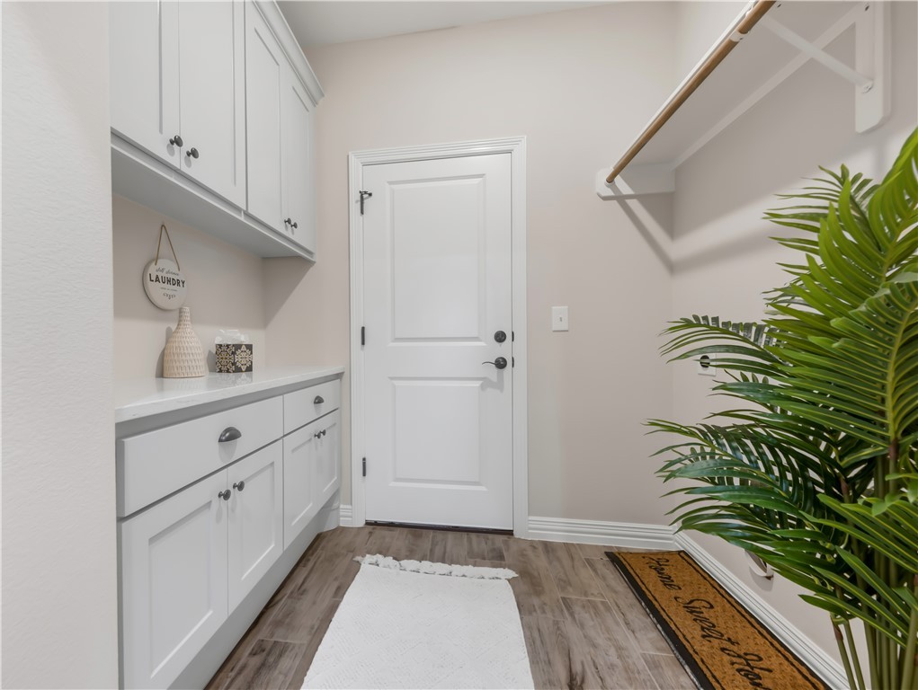 3310 Hunters Crossing Bryan, TX 77808 - Photo 20 of 34 Mudroom featuring light wood-style floors and baseboards