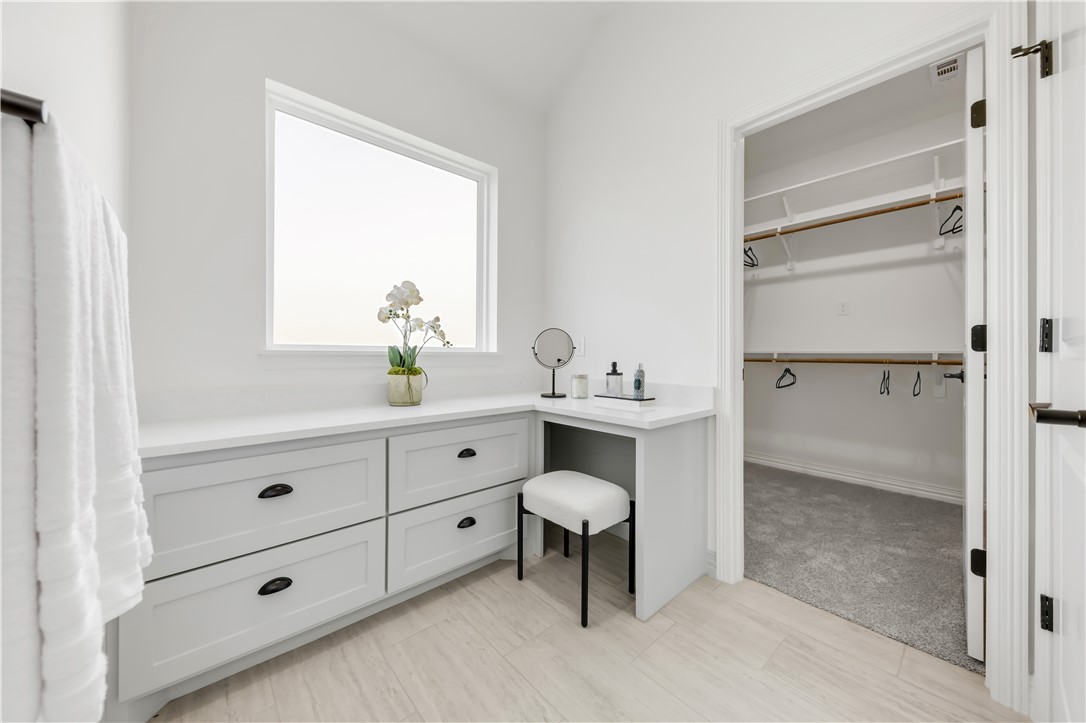 3310 Hunters Crossing Bryan, TX 77808 - Photo 23 of 34 Bathroom with vanity and a walk in closet