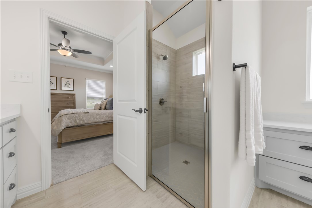 3310 Hunters Crossing Bryan, TX 77808 - Photo 24 of 34 Full bathroom with vanity, plenty of natural light, a shower stall, and ensuite bathroom