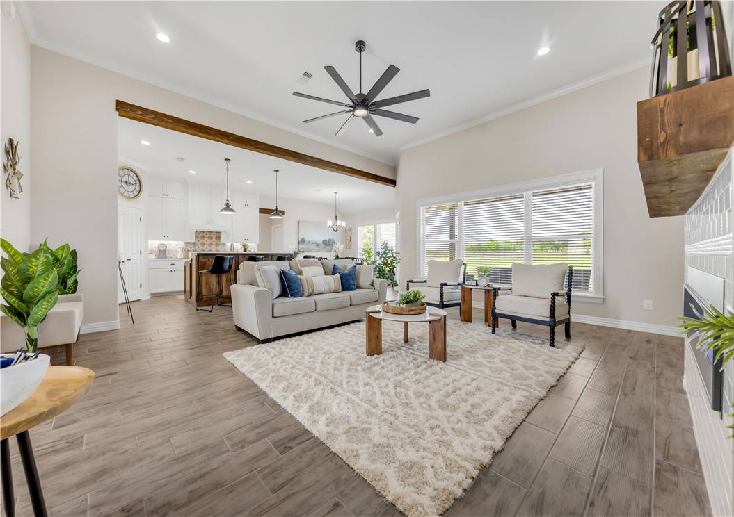 3310 Hunters Crossing Bryan, TX 77808 - Photo 8 of 34 Living area with light wood-style flooring, crown molding, a ceiling fan, recessed lighting, and a chandelier