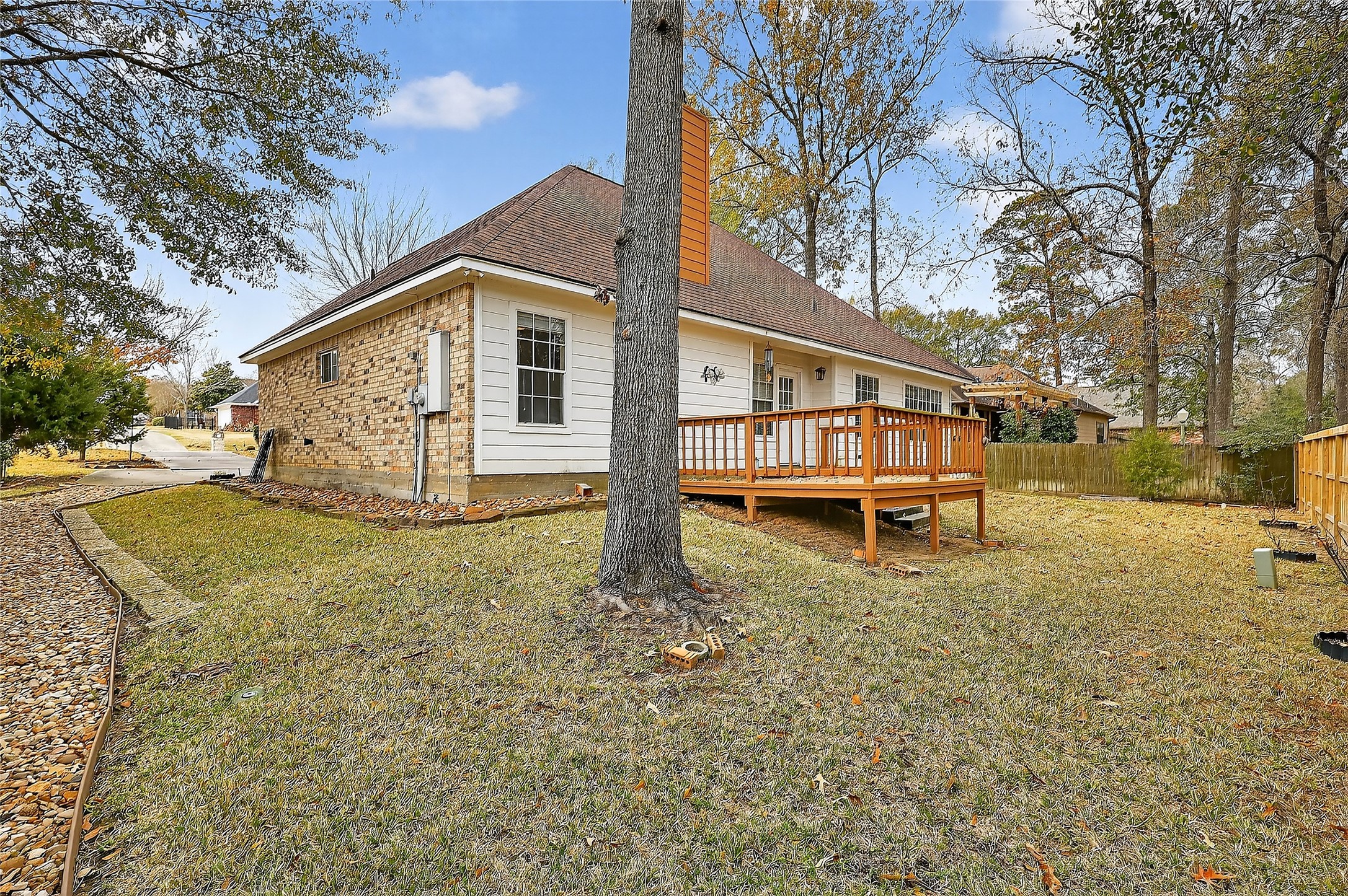 89 Dawns Edge Conroe, TX 77356 - Photo 16 of 46 Elevated wood deck overlooking the fenced backyard, offering functional outdoor living space surrounded by mature landscaping.