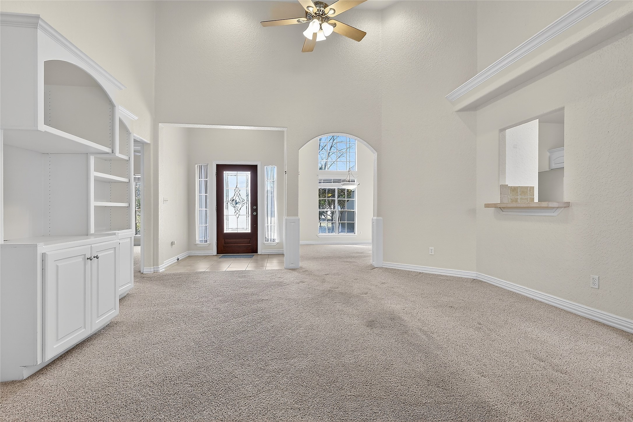 89 Dawns Edge Conroe, TX 77356 - Photo 20 of 46 Expansive living space showcases elevated ceilings, decorative cut-outs, and seamless flow to adjoining areas.