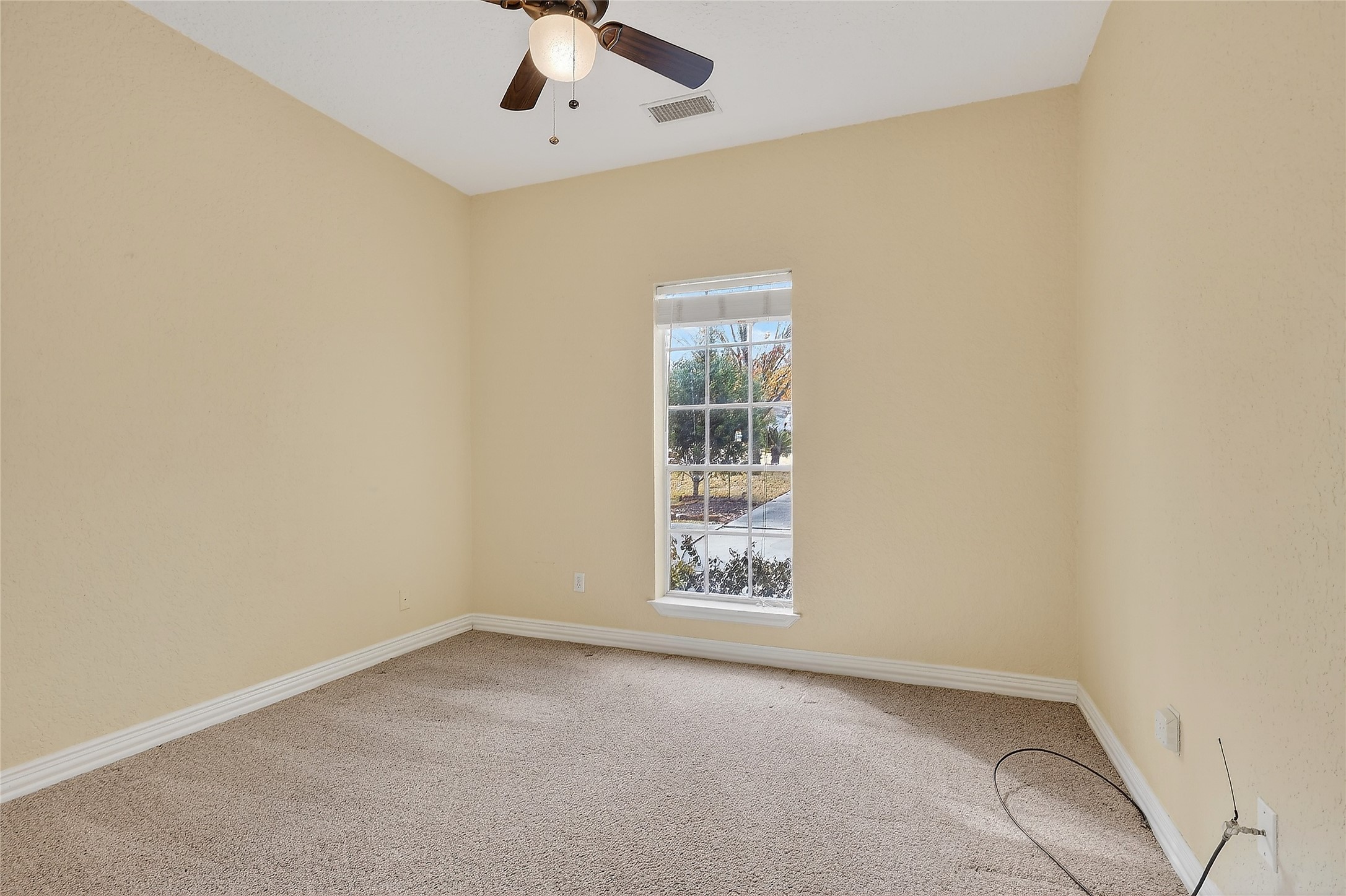89 Dawns Edge Conroe, TX 77356 - Photo 32 of 46 Comfortable secondary bedroom featuring soft carpet, neutral tones, and overhead fan.