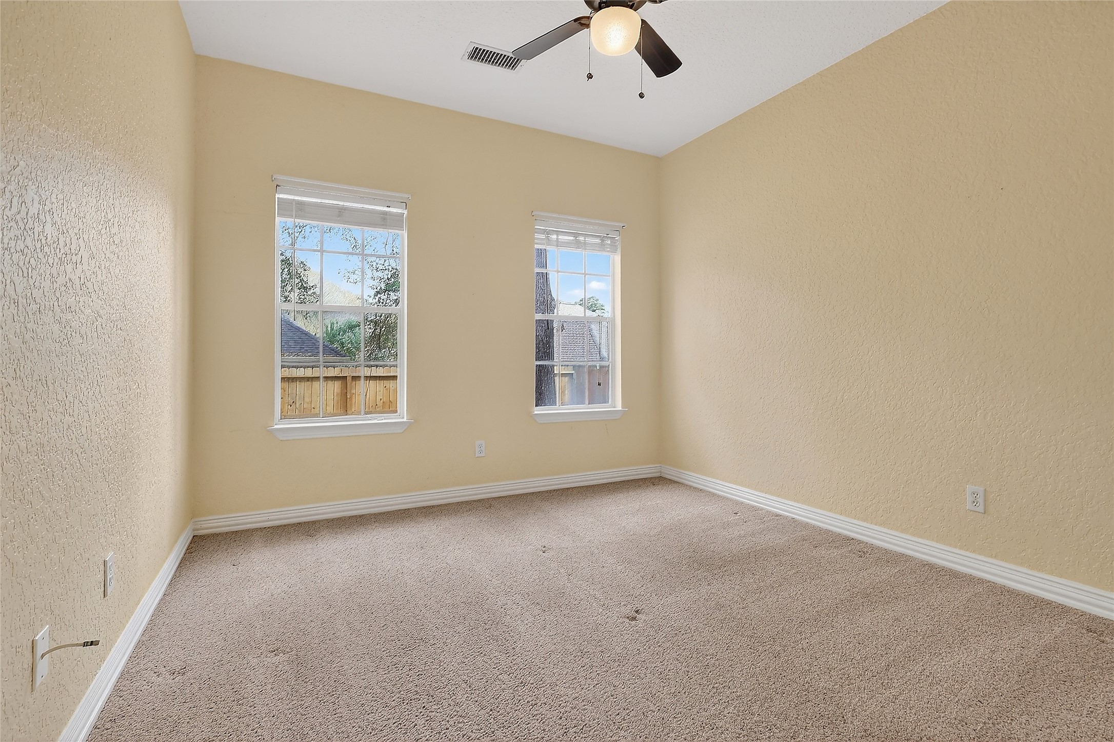 89 Dawns Edge Conroe, TX 77356 - Photo 35 of 46 Comfortable secondary bedroom showcases neutral tones, ceiling fan, and abundant natural light.