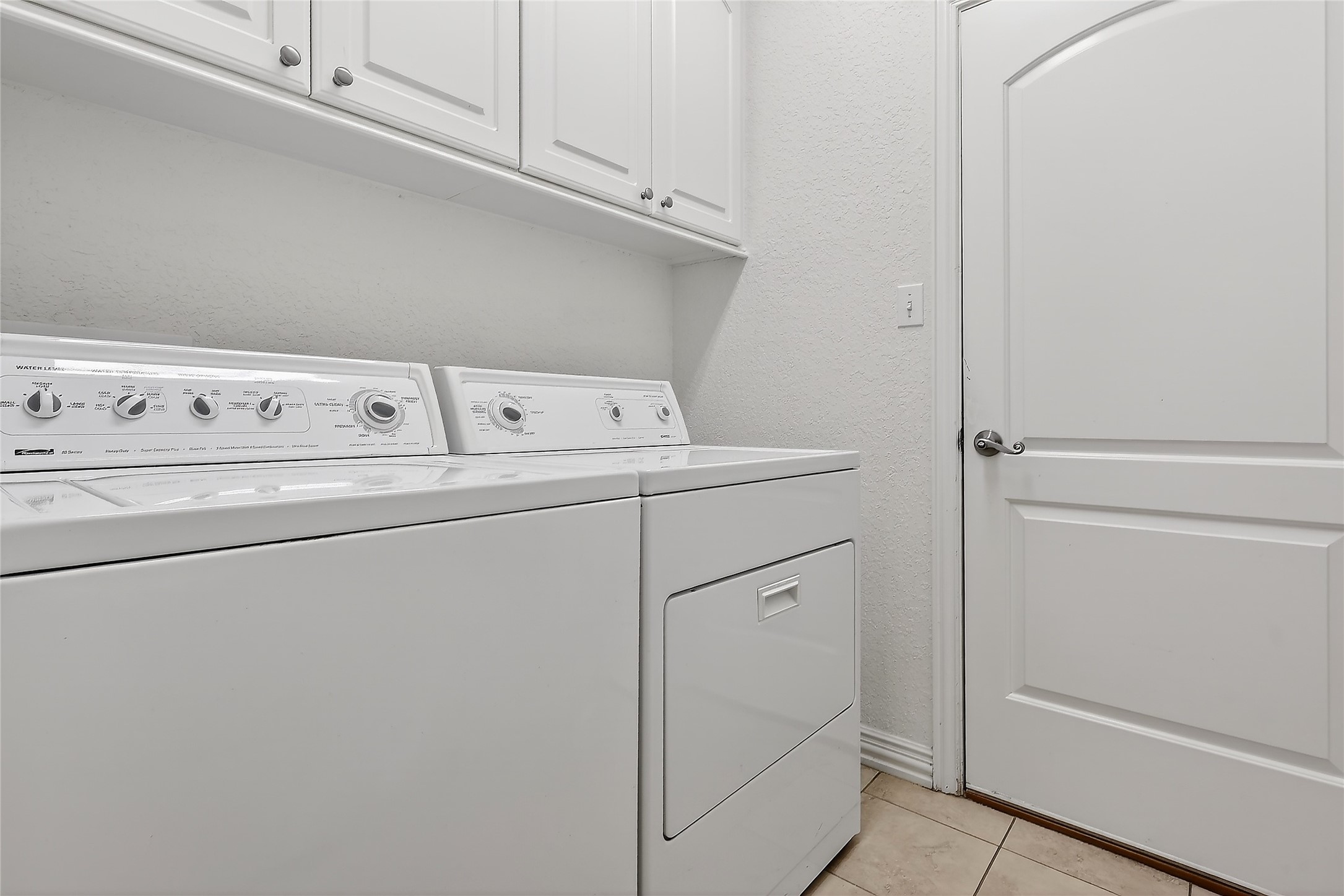 89 Dawns Edge Conroe, TX 77356 - Photo 39 of 46 Utility room with overhead storage cabinets; washer & dryer convey at closing.