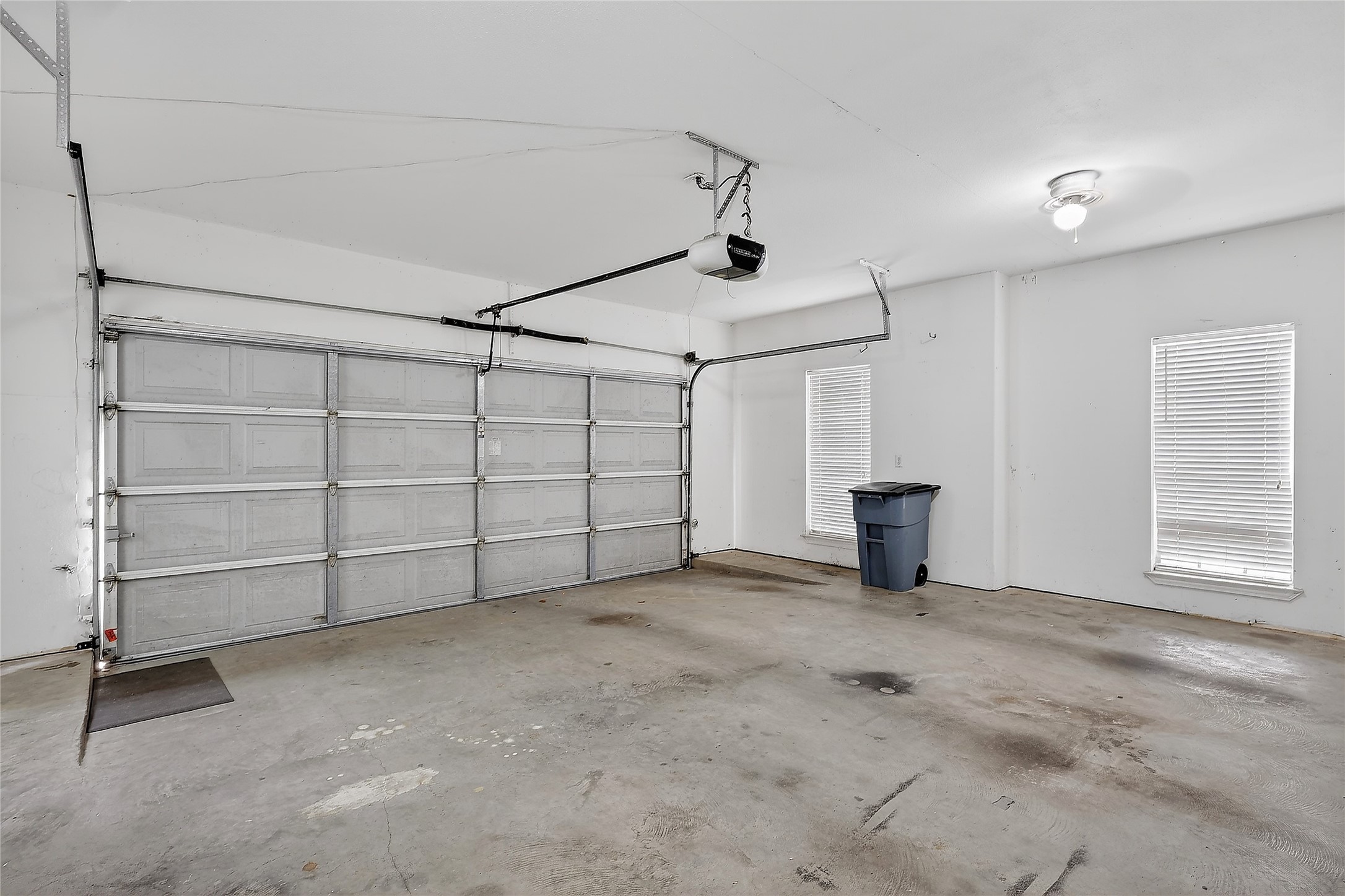 89 Dawns Edge Conroe, TX 77356 - Photo 41 of 46 Two-car garage featuring garage door opener, high ceilings, and room for storage.