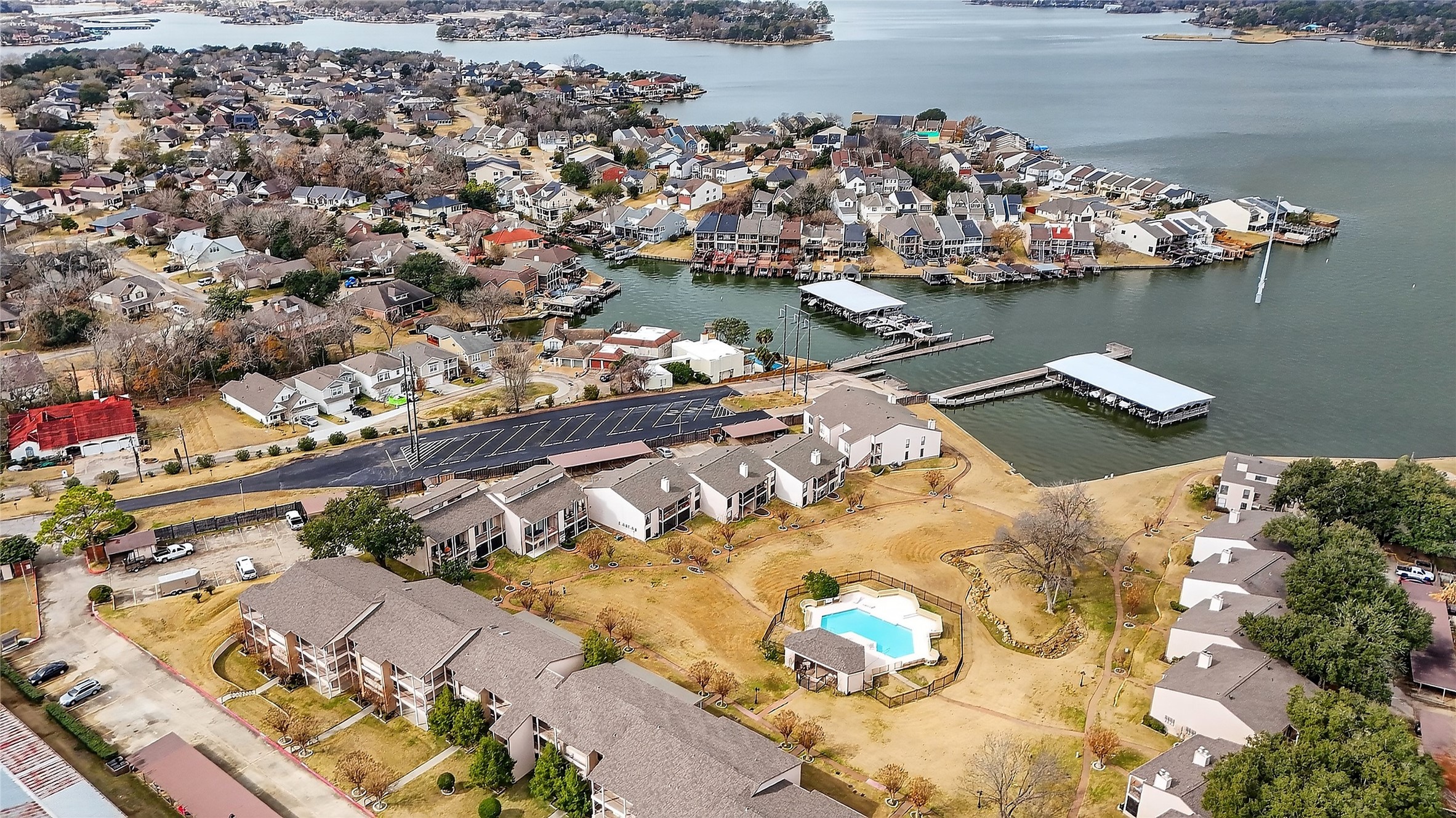 89 Dawns Edge Conroe, TX 77356 - Photo 44 of 46 Aerial view of April Sound’s waterfront Marina area on Lake Conroe, featuring community boat slips, lake access, and nearby residential enclaves within the gated neighborhood.