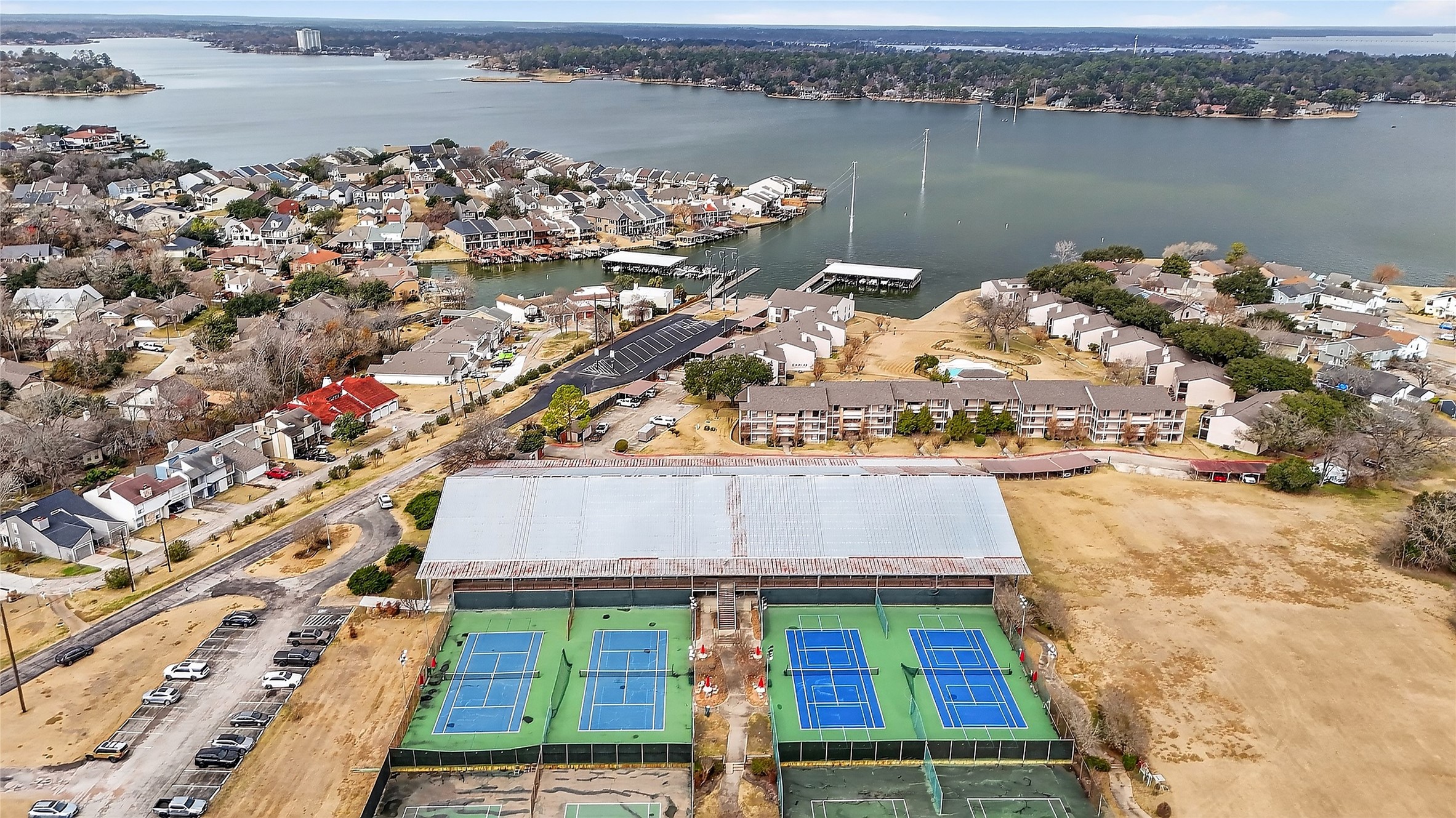 89 Dawns Edge Conroe, TX 77356 - Photo 45 of 46 April Sound racquet center showcasing covered tennis courts and pickleball facilities, part of the community’s full-service country club amenity package.