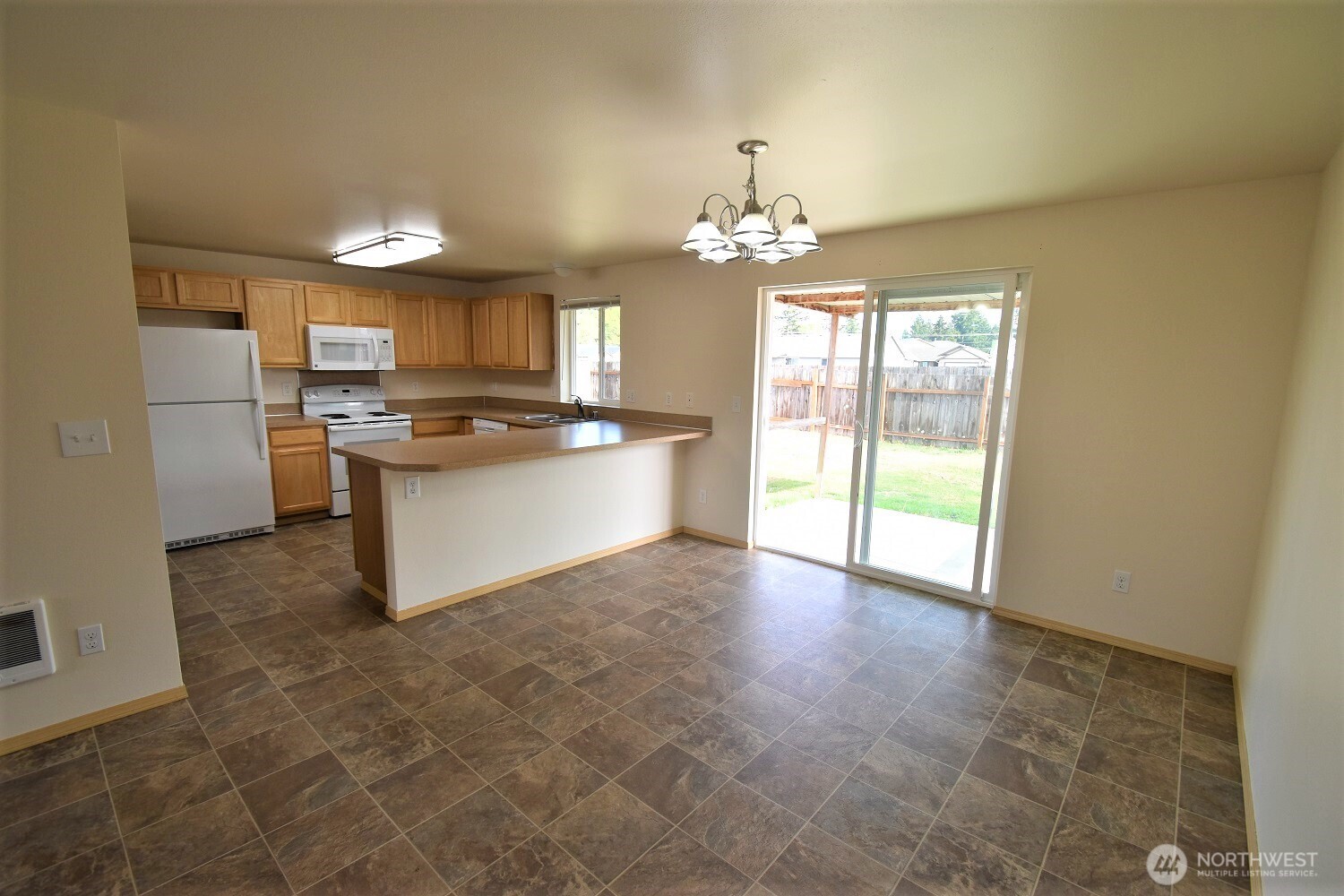 19906 Tamarack Drive Southwest Rochester, WA 98579 - Photo 3 of 12 a kitchen with kitchen island stainless steel appliances a chandelier and view of living room