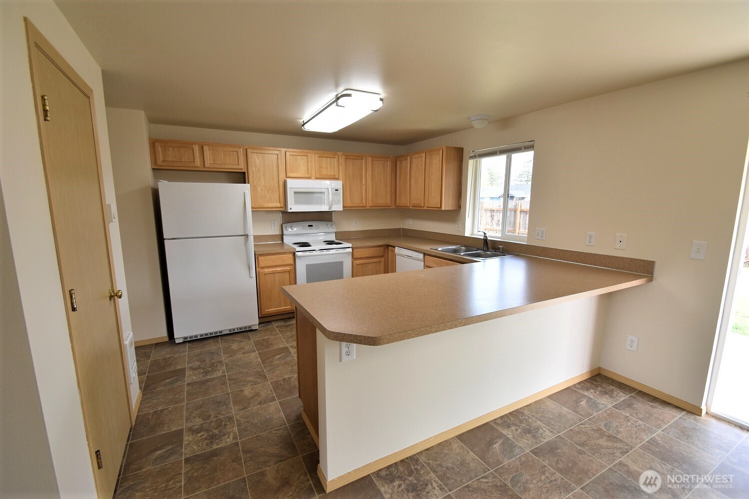 19906 Tamarack Drive Southwest Rochester, WA 98579 - Photo 4 of 12 a kitchen with refrigerator cabinets and a sink
