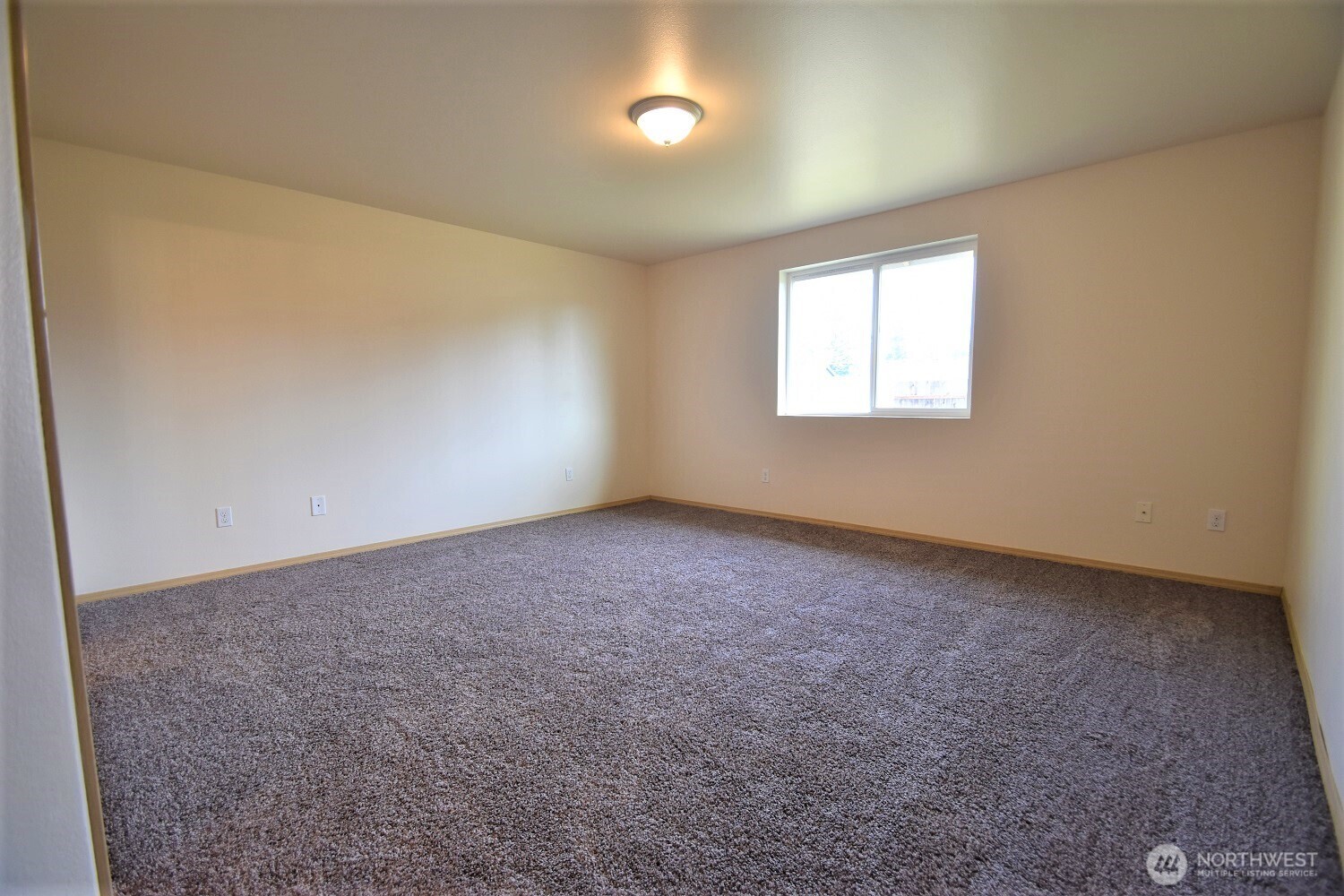 19906 Tamarack Drive Southwest Rochester, WA 98579 - Photo 8 of 12 an empty room with a empty space and windows