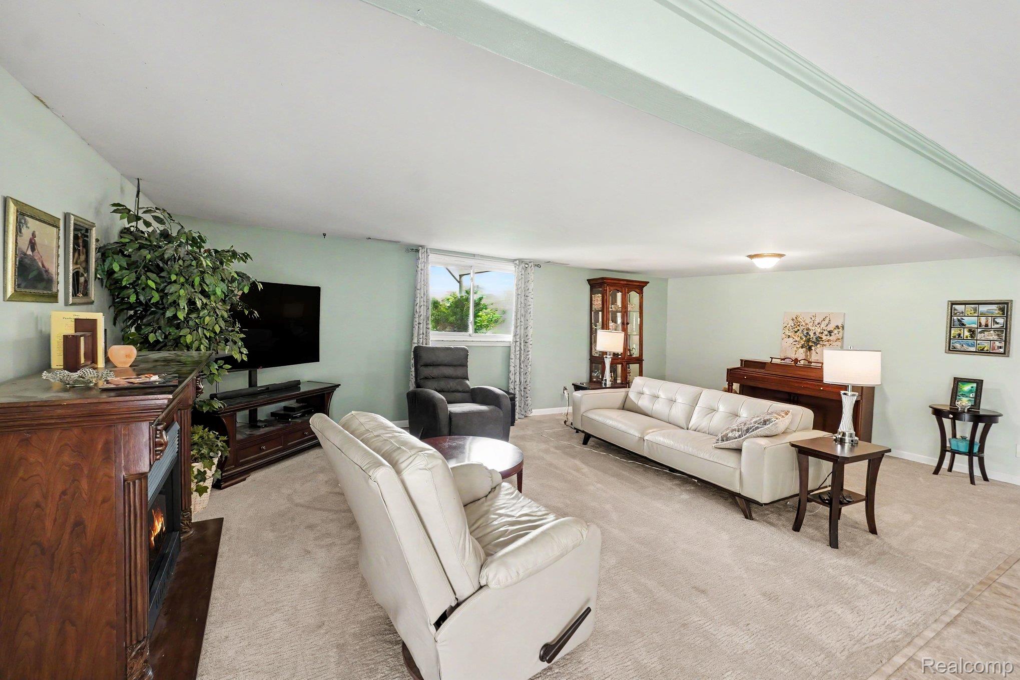 4848 Columbiaville Road Columbiaville, MI 48421 - Photo 18 of 35 Spacious living area featuring light-colored carpeting and pale green walls