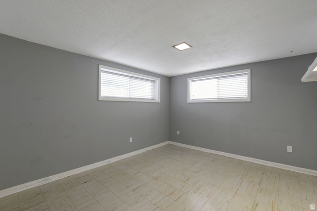 447 550 South Bountiful, UT 84010 - Photo 12 of 25 Room featuring light gray walls, two windows with white blinds, and light-colored tile flooring