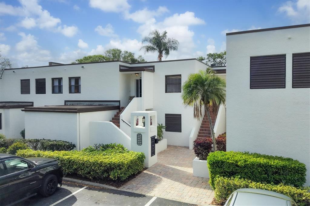 5058 Marsh Field Road, Unit 8 Sarasota, FL 34235 - Photo 1 of 73 a front view of a house with garden