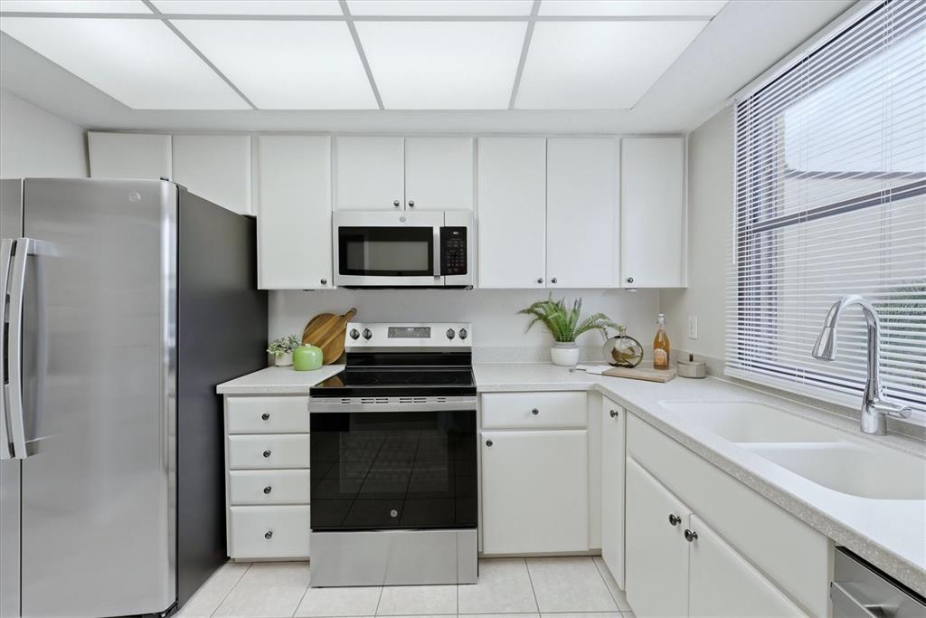 5058 Marsh Field Road, Unit 8 Sarasota, FL 34235 - Photo 13 of 73 a kitchen with stainless steel appliances a stove sink and refrigerator