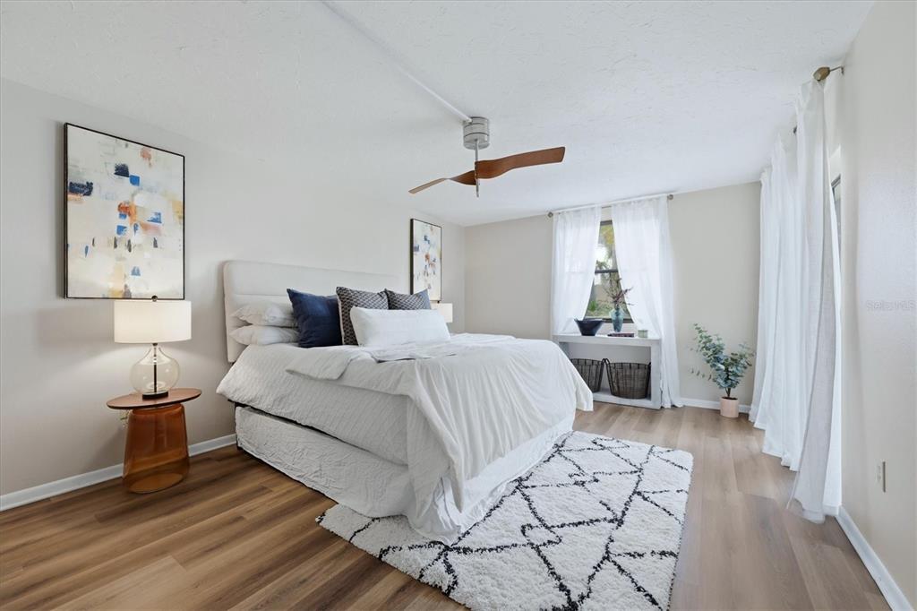 5058 Marsh Field Road, Unit 8 Sarasota, FL 34235 - Photo 15 of 73 a bedroom with a bed and a view of painting on the wall