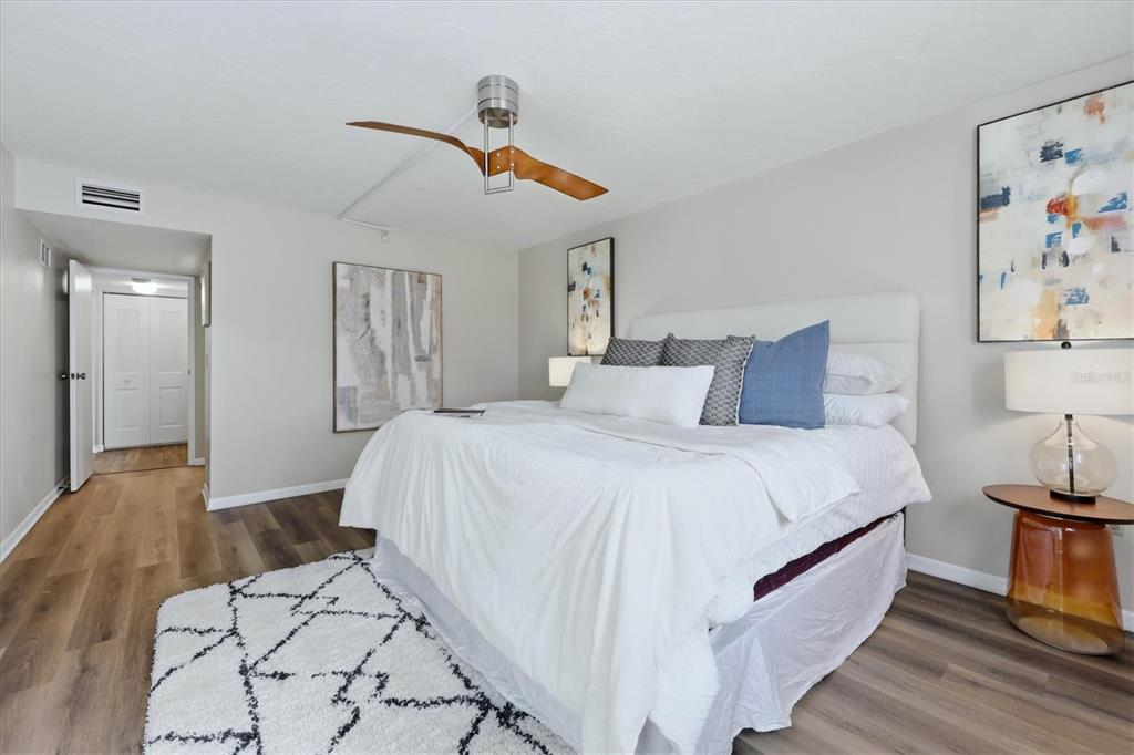 5058 Marsh Field Road, Unit 8 Sarasota, FL 34235 - Photo 16 of 73 a spacious bedroom with a bed and a lamp on table