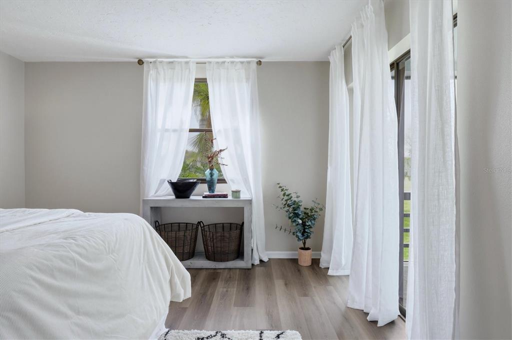 5058 Marsh Field Road, Unit 8 Sarasota, FL 34235 - Photo 17 of 73 a bedroom with a bed table and a window