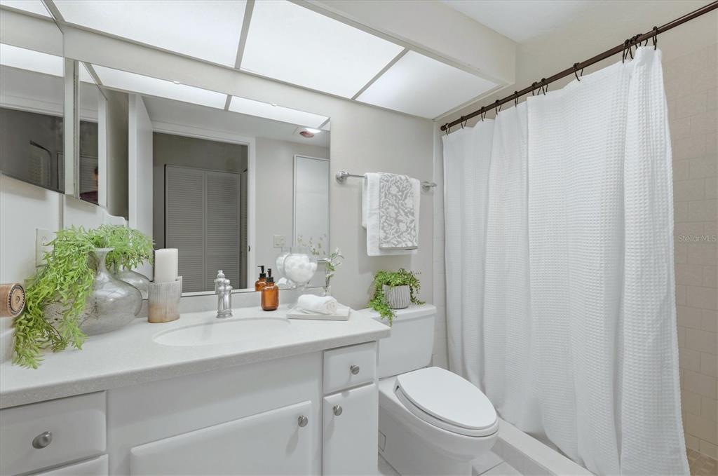 5058 Marsh Field Road, Unit 8 Sarasota, FL 34235 - Photo 18 of 73 a bathroom with a sink a toilet and shower curtain