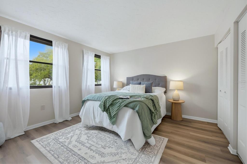 5058 Marsh Field Road, Unit 8 Sarasota, FL 34235 - Photo 20 of 73 a bedroom with a bed and wooden floor