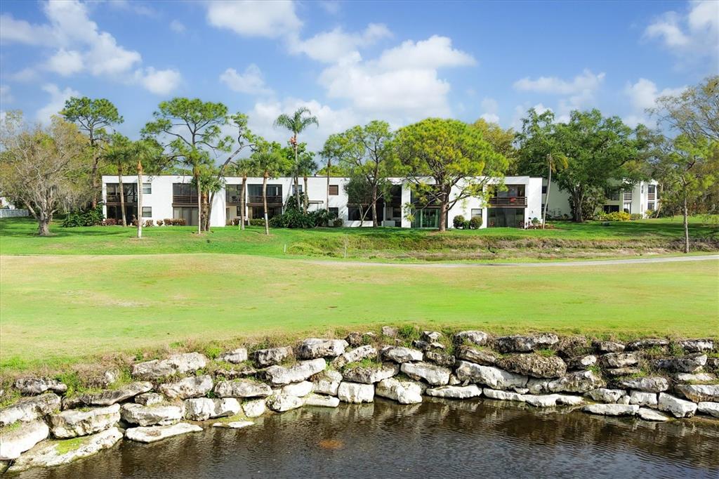 5058 Marsh Field Road, Unit 8 Sarasota, FL 34235 - Photo 30 of 73 a view of a house with a yard and lake view